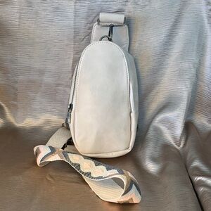 Crossbody small sling bag. Ivory cream color with adjustable strap.